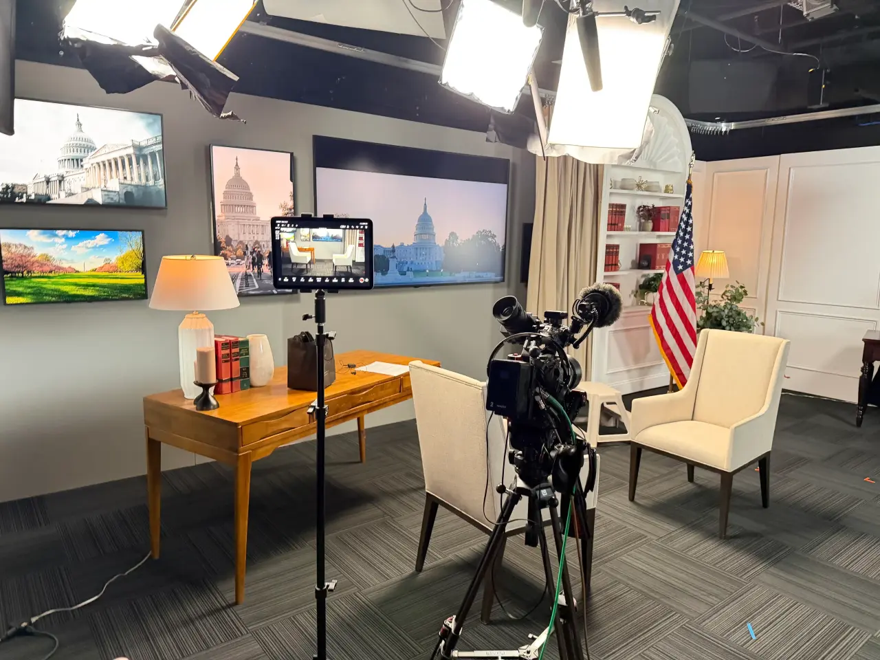 Broadcast interview set lit by Visual Vista Media: camera, softboxes and Capitol backdrops in a Washington studio