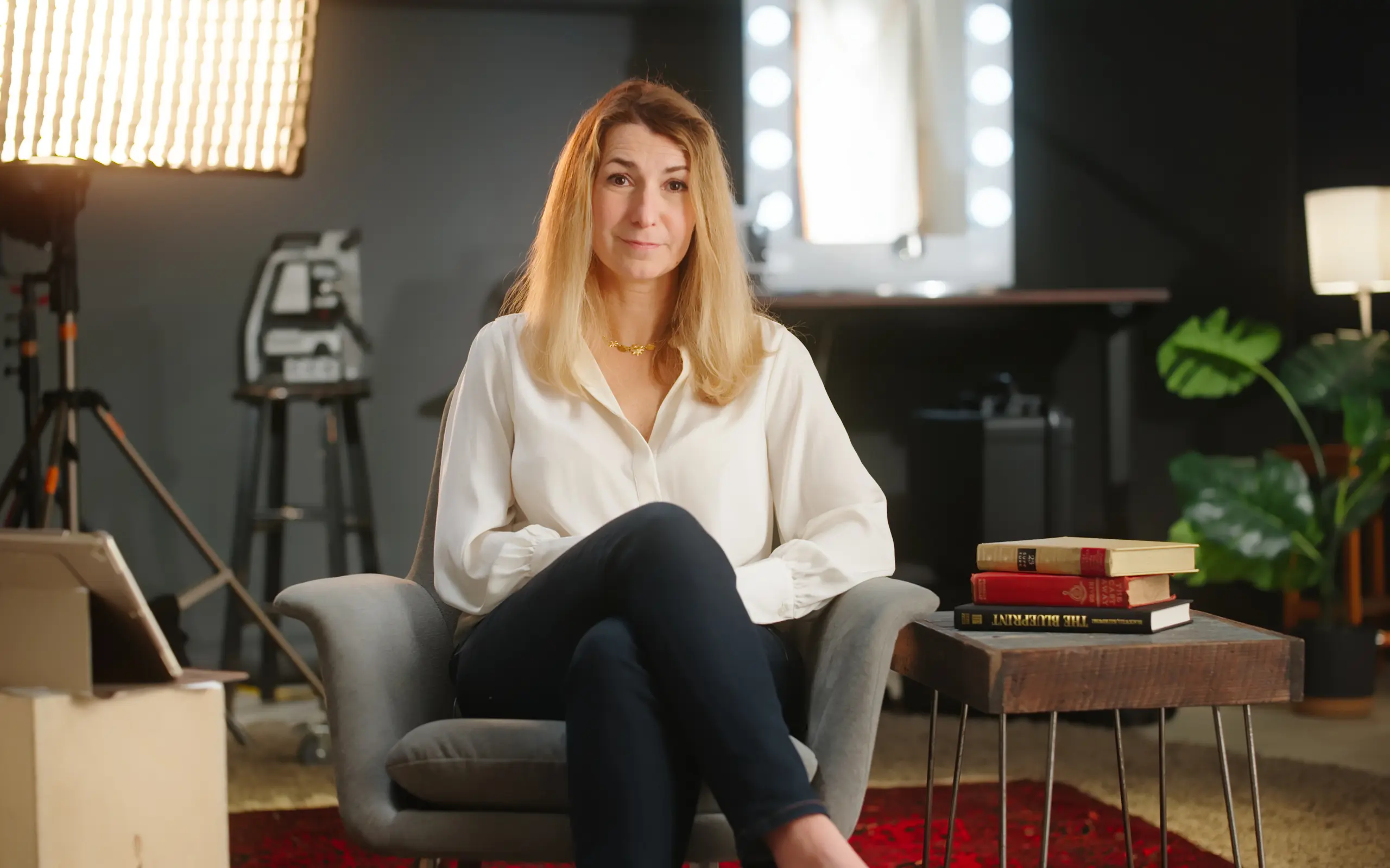 Interview subject seated in a warm-lit film studio